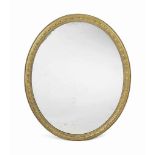 A VICTORIAN GILTWOOD OVAL MIRROR
LATE 19TH CENTURY
The original plate in a frame carved with lotus