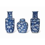 A PAIR OF CHINESE BLUE AND WHITE 'PRUNUS' ROULEAU VASES AND A JAR AND COVER
19TH CENTURY
Each
