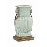 A CHINESE CELADON-GLAZED MOULDED VASE
THE PORCELAIN 19TH CENTURY
The square-sectioned vase with