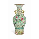 A CHINESE FAMILLE ROSE CELADON GROUND MOULDED VASE
19TH CENTURY
The vase applied with two gilt