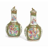 A PAIR OF CANTONESE FAMILLE ROSE BOTTLE VASES AND COVERS
19TH CENTURY
Decorated with shaped panels