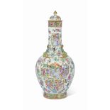 A CANTONESE FAMILLE ROSE BOTTLE VASE AND COVER
EARLY 19TH CENTURY
The vase is applied with four gilt