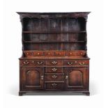 A SUBSTANTIAL GEORGE III OAK DRESSER
MID 18TH CENTURY, NORTH WALES
The pot-belly plate-rack with