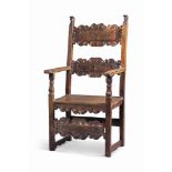 AN ITALIAN WALNUT ARMCHAIR
EARLY 18TH CENTURY
With scroll carved splats and matching stretchers,