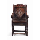 A SMALL WILLIAM AND MARY OAK ARMCHAIR
LATE 17TH CENTURY, PROBABLY WELSH
The scroll crest centred