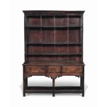 A GEORGE III FIGURED ELM POT-BOARD DRESSER
LATE 18TH CENTURY, SOUTH WALES
With three shelves