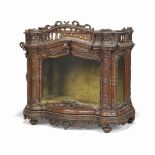 AN ITALIAN WALNUT RELIQUARY CABINET
18TH CENTURY
The glazed sides and plinth carved with foliate