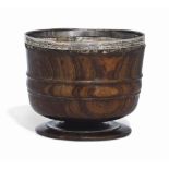 A CHARLES II LIGNUM VITAE WASSAIL BOWL
CIRCA 1680
With a raised moulded band flanked by reeded