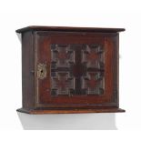 AN ENGLISH OAK SPICE CABINET
EARLY 18TH CENTURY
Carved with a moulded panelled front hinged to