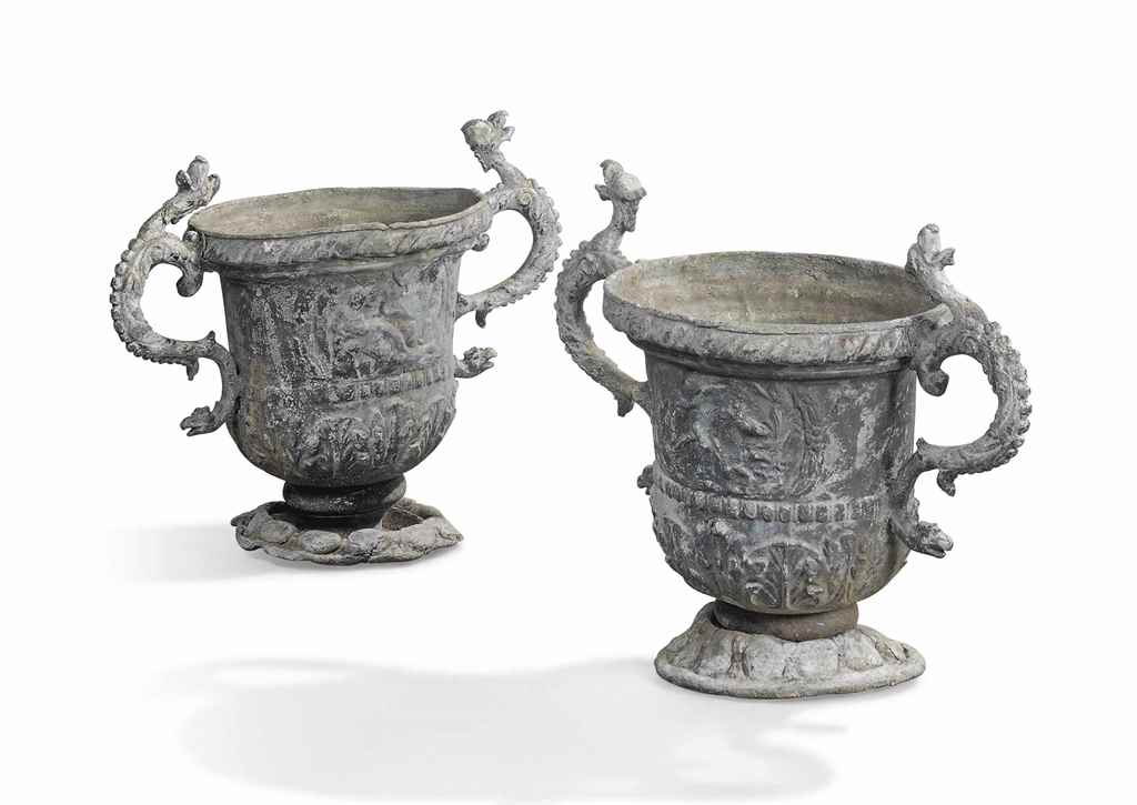 A PAIR OF GEORGE III LEAD GARDEN URNS
MID-18TH CENTURY
Each decorated in relief with cartouches