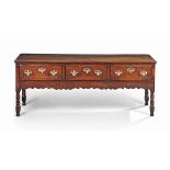 A GEORGE IV FIGURED OAK THREE-DRAWER DRESSER
EARLY 19TH CENTURY
With ogee-shaped friezes and ring-