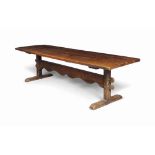 A LARGE EARLY VICTORIAN FIGURED ASH AND ELM TRESTLE TABLE
MID 19TH CENTURY
The figured ash four-