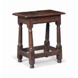 A CHARLES II OAK JOINED STOOL
LATE 17TH CENTURY
With channelled friezes and turned legs with