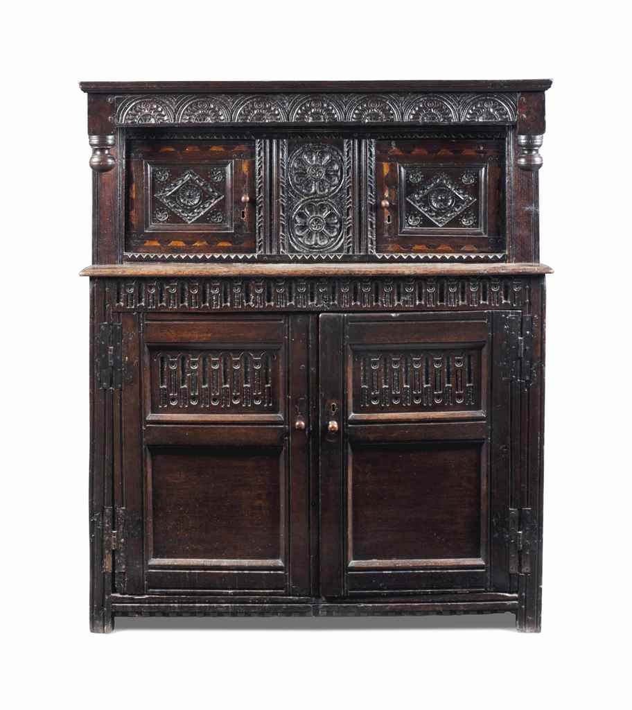 A CHARLES I OAK AND MARQUETRY PRESS CUPBOARD
EARLY 17TH CENTURY
Deeply carved and punch-decorated