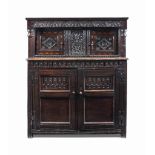 A CHARLES I OAK AND MARQUETRY PRESS CUPBOARD
EARLY 17TH CENTURY
Deeply carved and punch-decorated