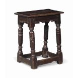 A CHARLES II OAK JOINED STOOL
LATE 17TH CENTURY
With scroll-edge friezes and ring-turned baluster