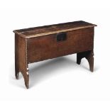 AN ELIZABETHAN OAK PLANK CHEST
LATE 16TH CENTURY
With hinged lid and sides extending to feet with