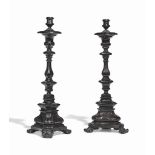 A PAIR OF PORTUGESE COLONIAL EBONY OR COROMANDEL CANDLESTICKS
18TH CENTURY
Each with triangular