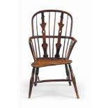 A GEORGE III YEW AND CHERRY WINDSOR ARMCHAIR
LATE 18TH CENTURY, THAMES VALLEY
With unusual shaped