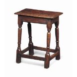 A CHARLES II OAK JOINED STOOL
MID 17TH CENTURY
With plain friezes and slender turned legs with