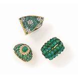 Three emerald and diamond rings, one by Chatila
The first of bombé design, the central cabochon