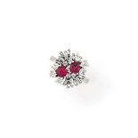 A ruby and diamond ring
Set with two cushion-shaped rubies, within a brilliant and baguette-cut