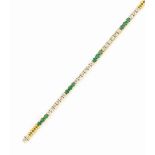AN EMERALD AND DIAMOND LINE BRACELET
Composed of alternating circular-cut emerald three-stone and