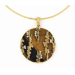 AN 18CT GOLD TIGER'S EYE QUARTZ AND DIAMOND PENDANT
The circular tiger's eye quartz circular pendant