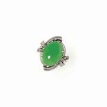A JADEITE JADE SINGLE-STONE RING
The cabochon jade within an engraved scrolling surround, ring