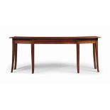 AN ENGLISH MAHOGANY SERVING-TABLE
BY PERKINS, STOCKWELL & CO. LTD, MID-20TH CENTURY
The shaped
