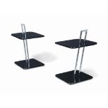 A PAIR OF CHROMIUM-PLATED-STEEL AND EBONISED TWO-TIER OCCASIONAL TABLES
BY CLASSICON, AFTER THE