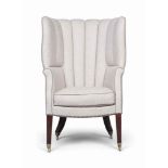 A LATE GEORGE III MAHOGANY WING ARMCHAIR
EARLY 19TH CENTURY
The padded barrel back, arms and seat