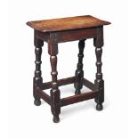 A CHARLES I OAK JOINED STOOL
EARLY 17TH CENTURY
With moulded top and unusual beehive-turned legs