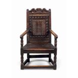 A LATE ELIZABETHAN / JAMES I FIGURED PINE ARMCHAIR
LATE 16TH / EARLY 17TH CENTURY, SCOTTISH
The