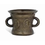 AN ENGLISH BRONZE HERALDIC MORTAR
17TH CENTURY
Cast with a pair of loop handles and four stag's