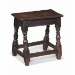 A CHARLES I OAK JOINED STOOL
EARLY 17TH CENTURY
With moulded-edge top and splayed bulbous legs