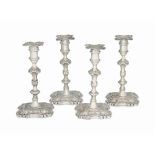 A MATCHED SET OF FOUR GEORGE II CAST SILVER CANDLESTICKS
MARK OF RICHARD GOSLING, LONDON, THREE