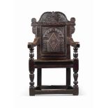 A CHARLES I OAK AND WALNUT ARMCHAIR
EARLY 17TH CENTURY, PROBABLY WELSH
With stiff-leaf and scroll