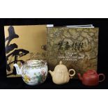 (lot of 4) Three Chinese teapots, one enameled porcelain with figures in a garden; one zisha pot