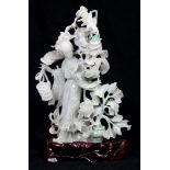 Chinese jadeite sculpture, a celestial beauty holding strings of coins, standing besides