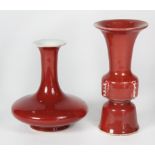 (lot of 2) Chinese ox blood porcelain vases; one trumpet neck with compressed body, bottom with