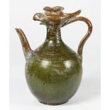 Chinese ceramic ewer based on a Tang prototype, overall coated with dark green glaze, with a phoenix