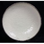 Chinese Ding type ceramic dish, molded with two fish surrounded by stylized floral scrolls, the