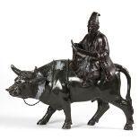 Japanese metal sculpture, of a scholar reading a scroll and seated on the back of an ox, 11"w.