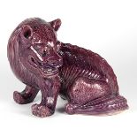 Chinese aubergine glazed porcelain mythical beast, seated on its haunches with the head turned to