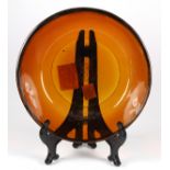 Chinese Peking glass shallow bowl, of amber hue with an incised band below the wide mouth, the