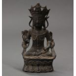 East Asian bronze Guanyin, the benevolent face topped with a five point diadem, seated on a double