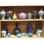 Two shelves of Chinese cloisonne items, including vases, lidded jars, brush washer and a squash