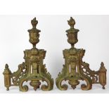 Louis XV style patinated bronze chenets, each having a flame finial above an urn, rising on a