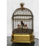 Continental caged bird automaton, executed in gilt brass, depicting a polychrome decorated bird on a